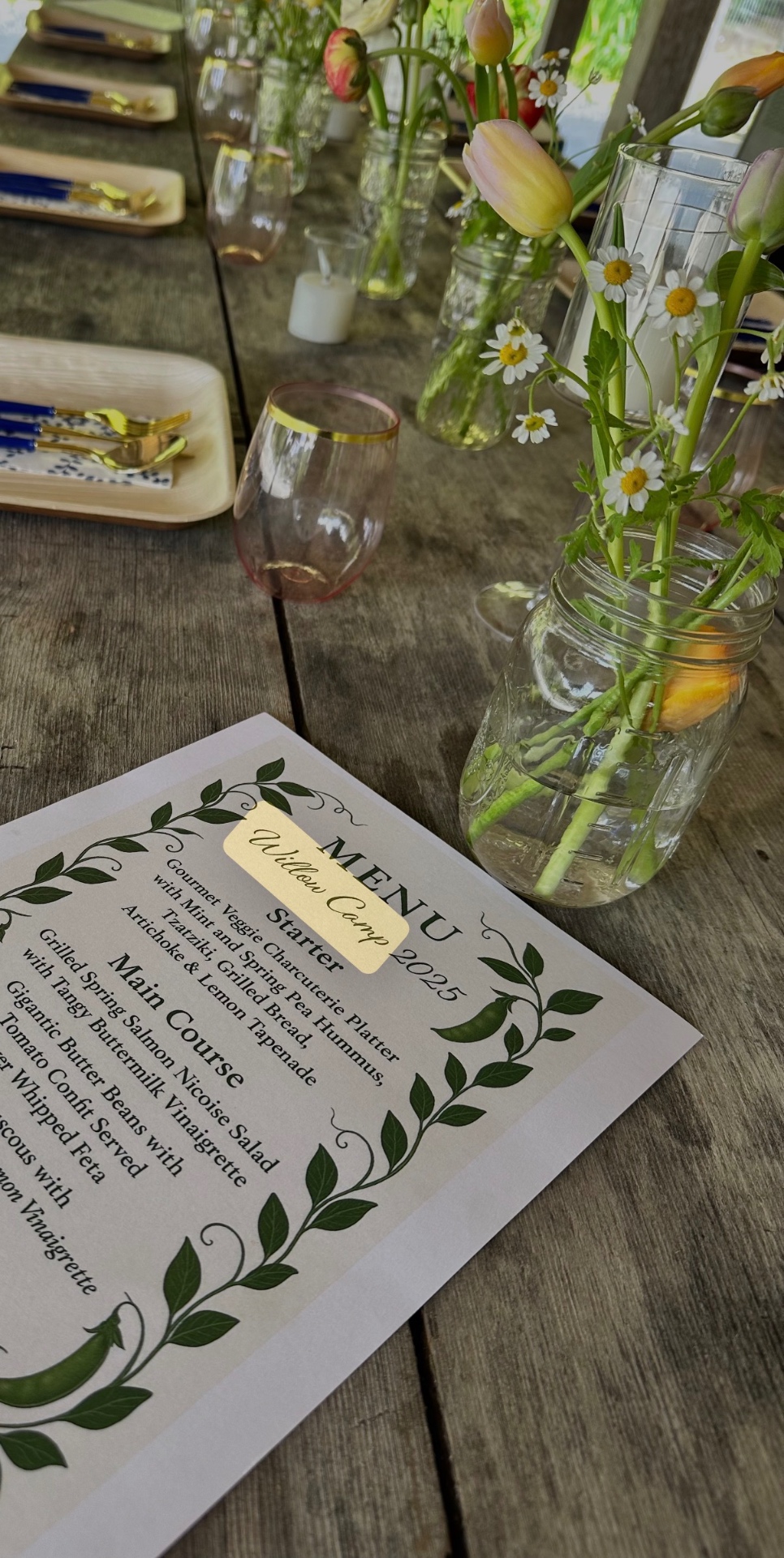 Set table with menu, flowers, and place settings